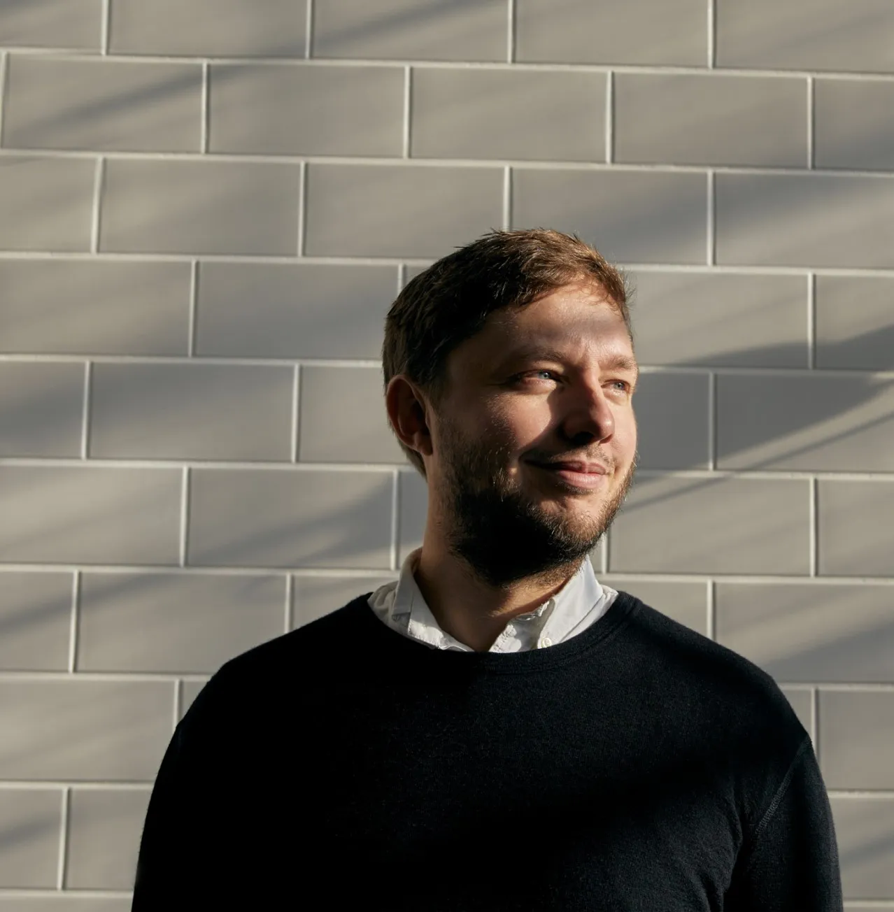 Businessman in front of a tile wall